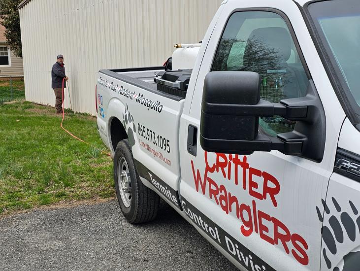 Critter Wranglers technician with service van