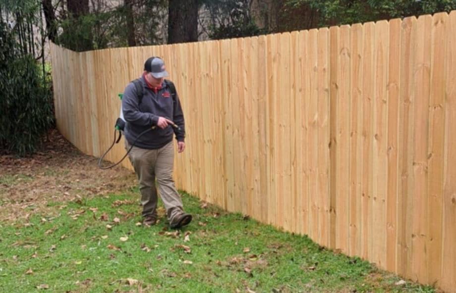 Critter Wranglers technician performing yard treatment for fire ants
