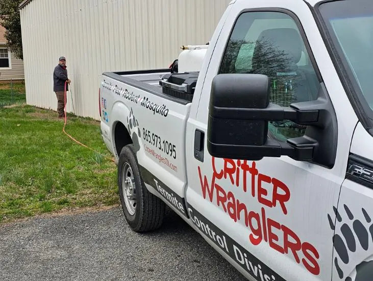 Critter Wranglers technician with service van
